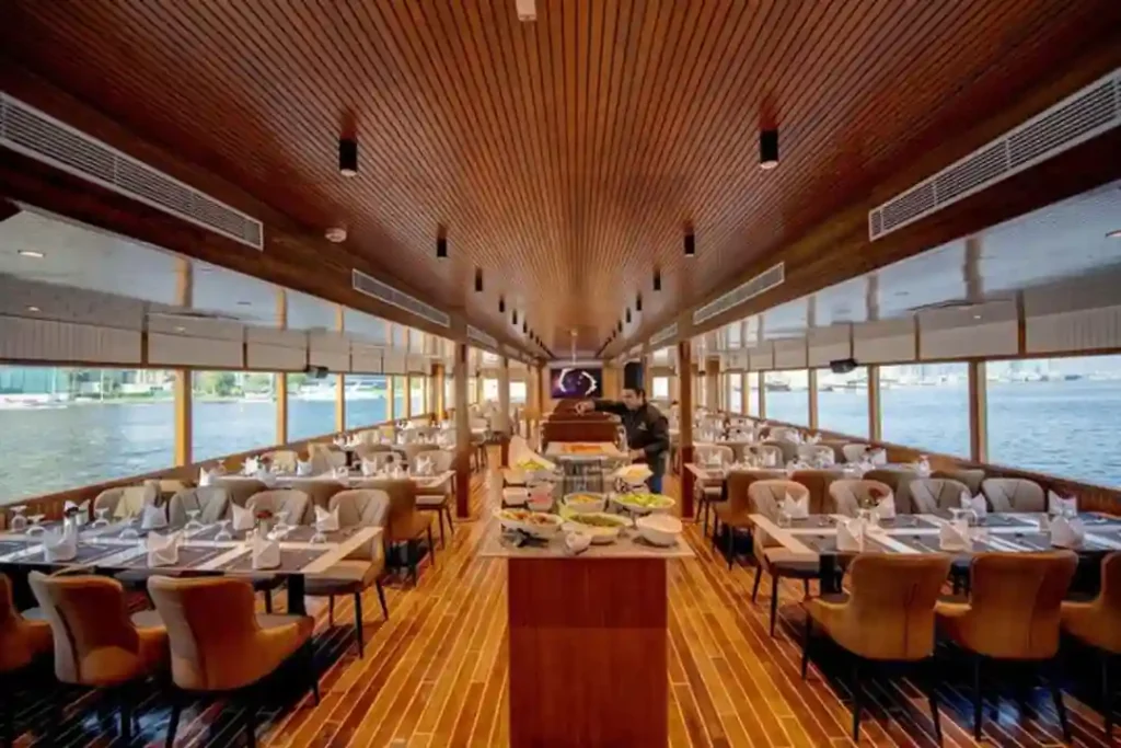 Cozy indoor dining hall onboard dhow cruise Dubai Marina.