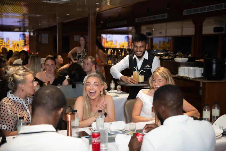 Guests having a joyful evening on a Dubai Marina dinner cruise